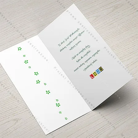 Karnet WN3-091 Wielobarwne pisanki wśród liści, otwarty na stole, środek z miejscem na życzenia i logo