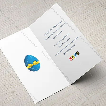 Karnet WN3-111 Błękit i życzenia dwujęzyczne, otwarty na stole, środek z miejscem na życzenia i logo